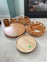 All items displayed together showing four Lazy Susans and two napkin holders in wood finish