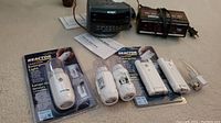 Photo of all items including two clock radios (Sony and Cosmo Time), two Reactor emergency lights (one in packaging, one unboxed), and a night light.