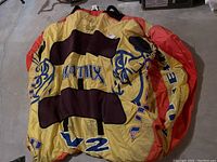 Two yellow-orange circular AirHead Matrix V2 inflatable watersports tubes laid flat on floor with visible black handles and patches.