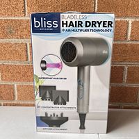 Front of sealed box showing product image, branding, and included attachments (2 concentrators and 1 diffuser).