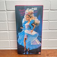 Front view of the boxed Evening Sparkle Barbie Doll showing the doll in her formal blue and pink iridescent gown with puffed sleeves.