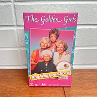 Front of the game box showing the four Golden Girls characters with title 'Any Way You Slice It'
