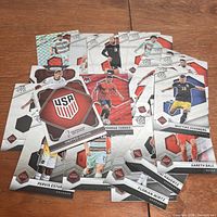Panini FIFA soccer trading cards arranged showing various players and a USA team emblem card.