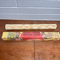 Photo of the drawer liner roll and its original box showing artwork and product name.
