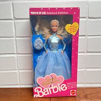 Front view of Sweet Romance Barbie doll in original Toys R Us Limited Edition box showing doll wearing a blue shiny halter top, blue tulle skirt, and holding a blue fragrance locket purse.