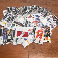 Spread of Upper Deck NHL hockey trading cards showing several players and a red jersey patch card.