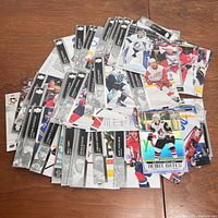 Top view of a spread of NHL hockey trading cards by Upper Deck showing various players, team logos and special edition cards.