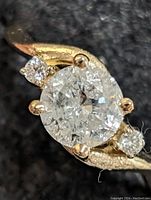 Top view close-up of center diamond and side stones on black background