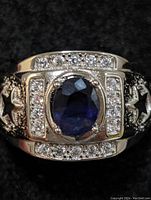 Front view showing oval sapphire center and surrounding CZ accents