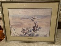 Framed western scene print "The Signal" by Charles M. Russell, visible number 803 of 1000, showing a cowboy waving a flag above a herd of cattle with expansive landscape in background.