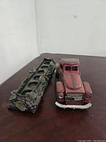 Red vintage truck and grape vine holder shown on a table, highlighting decorative details and condition.