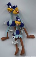 Three vintage Looney Tunes Roadrunner plush dolls showing full body, standing and sitting position, displaying blue and brown color scheme and facial details.