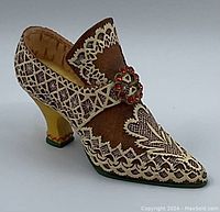 Front and side view of vintage replica shoe figurine showing intricate lace and jewel details