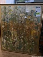 Full view of the framed abstract trees painting in earth tones with drip technique