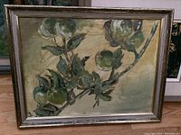 Framed oil painting of green apples on a branch with leaves, highlighting detailed brush strokes and muted green and brown tones.