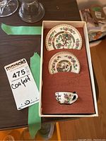 Photo of miniature teacup and two saucers in original Coalport box.