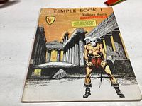 Front cover photo of Temple Book I showing illustrated temple and minotaur figure with title and author name.