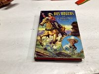 Front cover of the 1945 Roy Rogers book showing the title and illustration of Roy Rogers on horseback and a portrait inset.