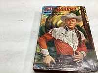 Front cover of Roy Rogers book with color illustration of Roy Rogers in cowboy outfit