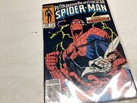 Front cover photo showing the Spider-Man comic book issue #106 with the character on cover and colorful lightning background.