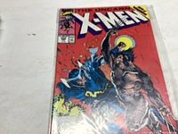 Front cover of The Uncanny X-Men comic book issue 258 showing the title and colorful fight scene between two characters.