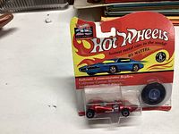 Front view of unopened 1992 Hot Wheels car in original packaging showing model and plastic-wrapped spare tire.