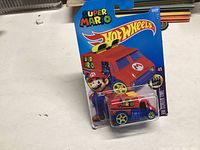 Unopened Hot Wheels Super Mario Van toy vehicle in original retail packaging on blue cardboard backing with branded header.