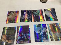 Eight holographic Pokémon cards arranged face-up on a flat surface.