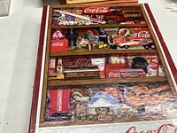 Wooden frame Coca Cola puzzle showing vintage trucks, bottles, and soda branding in multiple compartments.
