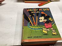 Front cover of 1934 Mickey Mouse Annual book featuring Mickey in baseball gear with bats and ball.