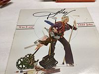 Front cover of Dolly Parton's 9 to 5 and Odd Jobs vinyl album with artwork of Dolly carrying work tools.