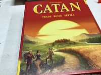Top cover of Settlers of Catan game box with artwork and title