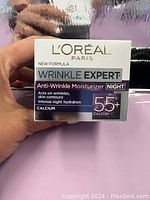 Photo of the front of the sealed box of L'Oreal Paris Wrinkle Expert 55+ Night Anti-Wrinkle Moisturizer showing product information and branding.