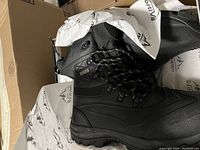 Pair of men’s black boots, size 11, new in box with branded paper wrapping
