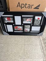 Photo showing a black 8-section photo frame containing placeholder images of flowers, a Canadian flag, and a red chair.