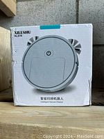 Front side of the box showing the robot vacuum cleaner image and brand/model information.