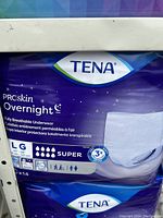 Photo of sealed TENA ProSkin Overnight Underwear package size LG with product details visible on front.