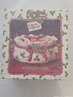 Box of Fitz and Floyd Deck The Halls decorative ceramic bowl showing holiday-themed graphics and the brand name.