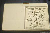 White box with black text and logo for I Love Lucy Alarm Clock, item #14224, manufactured by Vandor in 1998, handmade in China.