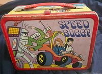 Front side of Speed Buggy metal lunchbox showing cartoon characters and Speed Buggy vehicle with red trim and handle.