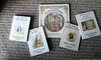 Five vintage children's books arranged on carpet: The Foxwood Treasure and four Beatrix Potter tales, showing cover art and titles.