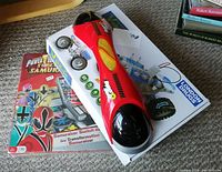 Three games stacked: Hyper Slide electronic game on top, Power Rangers Super Samurai board game, Salt Water Fueled Space Vehicle build kit box. Items shown in original packaging or with visible graphics and buttons.