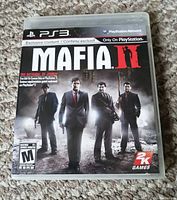 Front cover of Mafia II PS3 game case showing title, ESRB Mature rating, and four male characters in suits.