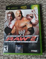Front cover of WWE Raw 2 Xbox game case showing artwork, ESRB rating, and branding