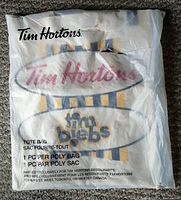 Photo of sealed Tim Hortons poly bag containing the Justin Bieber tote bag, shows Tim Hortons logo and Tim Biebs branding.