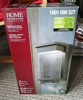 Front view of packaging showing brand, model number, lantern image, and specifications including LED technology and dimensions.