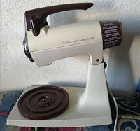 Sunbeam Mixmaster vintage stand mixer base with brown handle and base plate, no bowls attached.