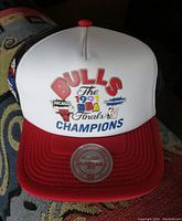 Front view of white and red adjustable Chicago Bulls hat with 1991 NBA Finals Champions text and logos.