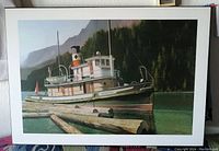 Print showing the S.S. Master boat in a lake with forest and mountains in background, mounted on heavy board with white border.