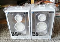Front view of two sealed Ye!! Clearholic Bluetooth speakers in packaging showing front drivers and branding.